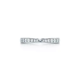 Close-up of Tiffany Harmony® platinum band ring showing bead-set round brilliant diamonds on a gently tapered 1.8 mm band.
