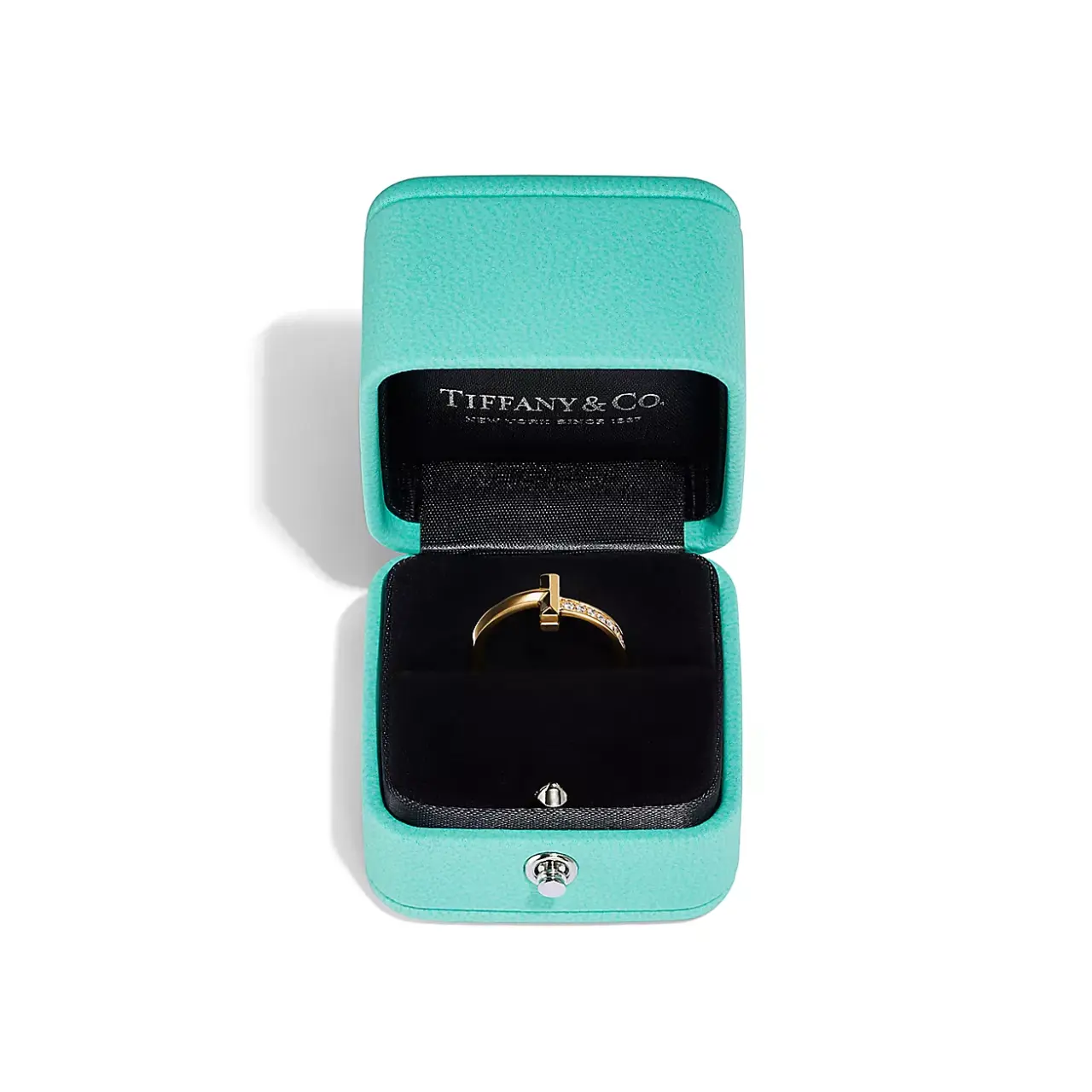 The Tiffany T1 Ring worn on hand, illustrating its modern aesthetic and diamond accents.