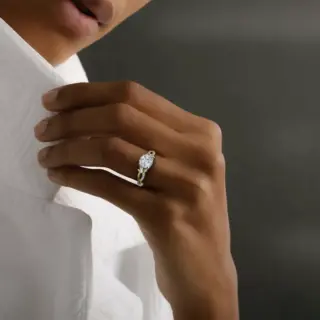 VRAI engagement ring with intertwined pavé band and center round diamond in white gold floral setting