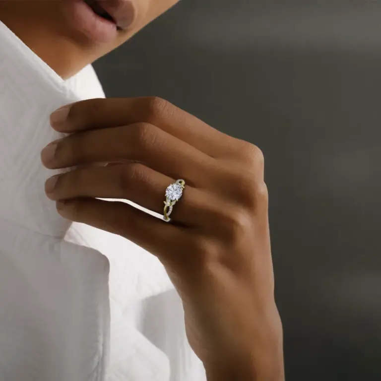 VRAI engagement ring with intertwined pavé band and center round diamond in white gold floral setting