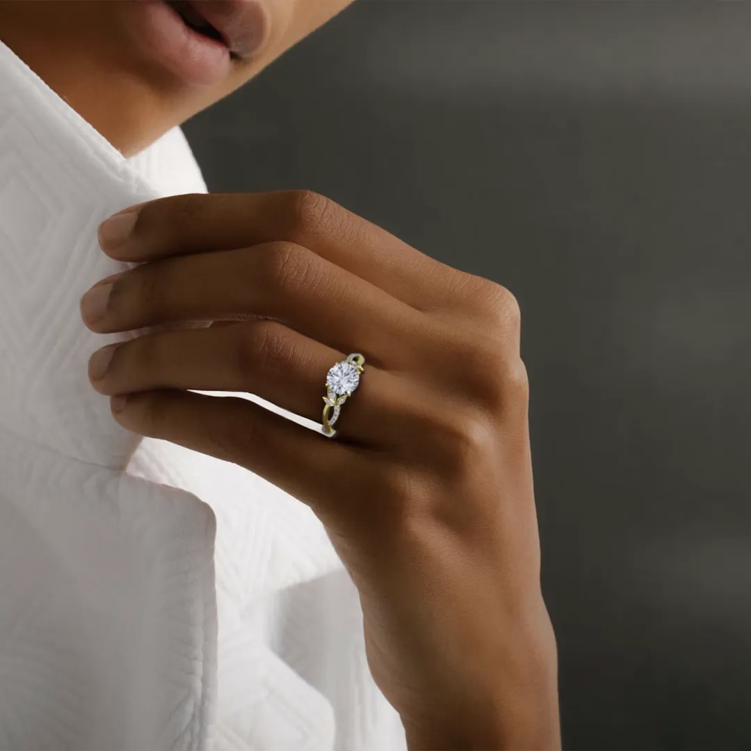 VRAI engagement ring with intertwined pavé band and center round diamond in white gold floral setting