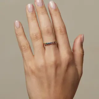 Colorful eternity ring with seven rainbow gemstones bezel‑set in yellow, white, or rose gold—Aura by Sofia Kaman