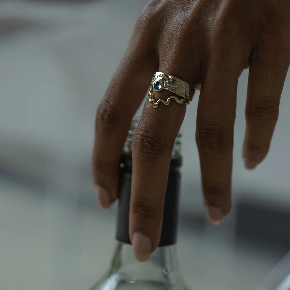 Side profile of the White Diamond & Cabochon Sapphire Flux Ring, emphasizing the smooth 14k yellow gold band and the seamless integration of the gemstones.