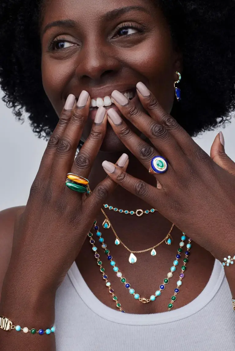 Model wearing 14K yellow gold Wise Monkeys Ring with diamond eyes, highlighting its whimsical design and symbolic mantra