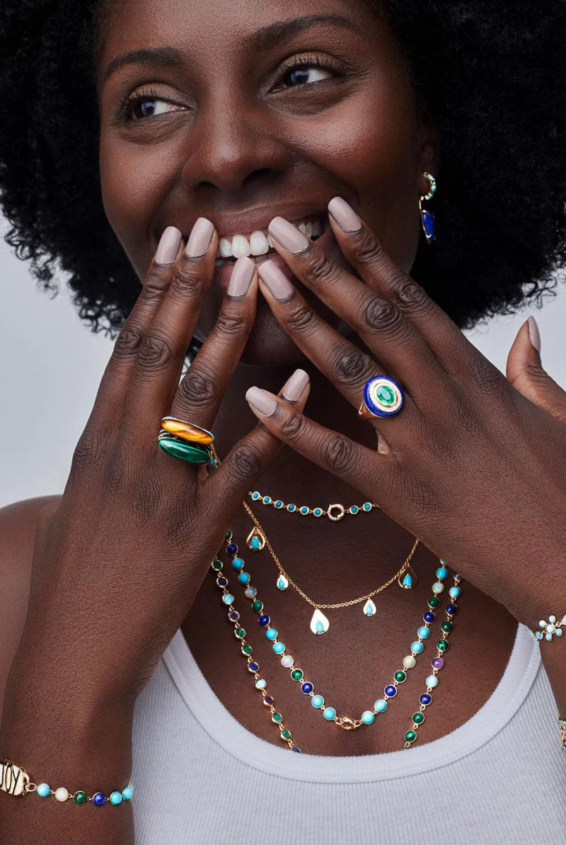 Model wearing 14K yellow gold Wise Monkeys Ring with diamond eyes, highlighting its whimsical design and symbolic mantra