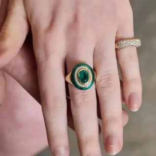 Close-up of Wise Monkeys Ring in 14K yellow gold, focusing on the sculpted monkey faces with white diamond eyes and engraved mantra inside.